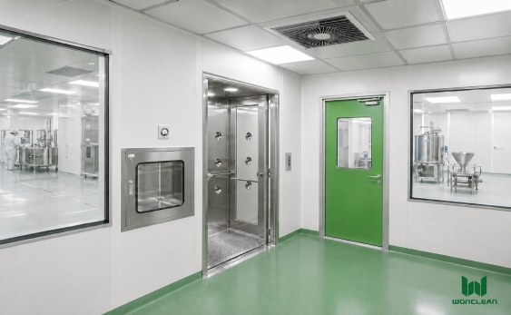 Pharmaceutical engineering cleanroom with green cleanroom doors, transfer equipment and controlled production area