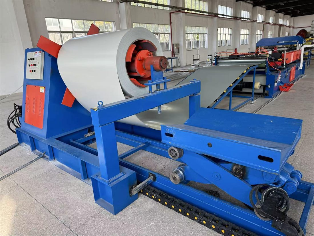 Cleanroom sandwich panel production line with a coil of pre-coated steel feeding the laminating machinery