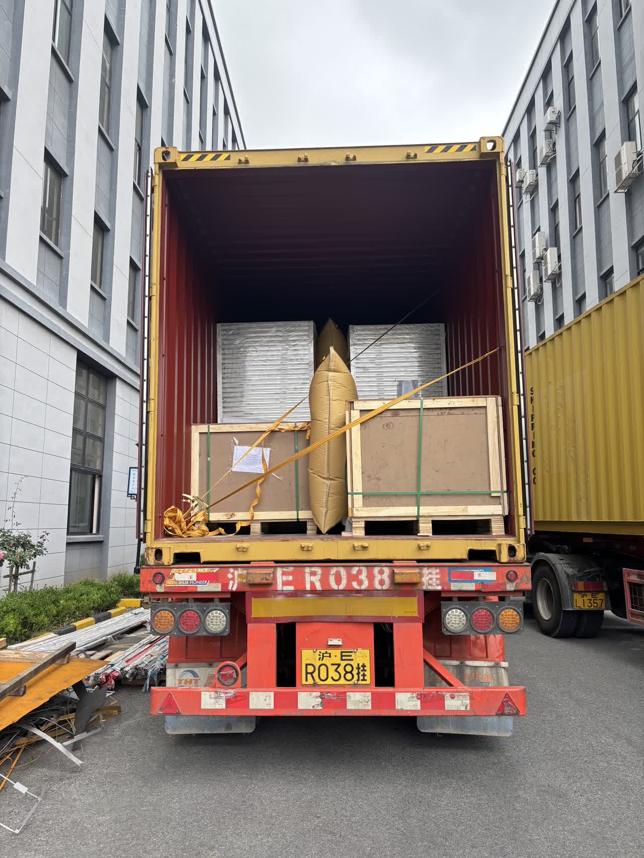 Cleanroom wall panels and crated components loaded into an export container for rapid deployment