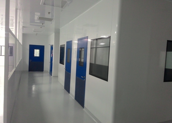 GMP pharmaceutical cleanroom corridor with blue cleanroom doors and pressure zoning layout