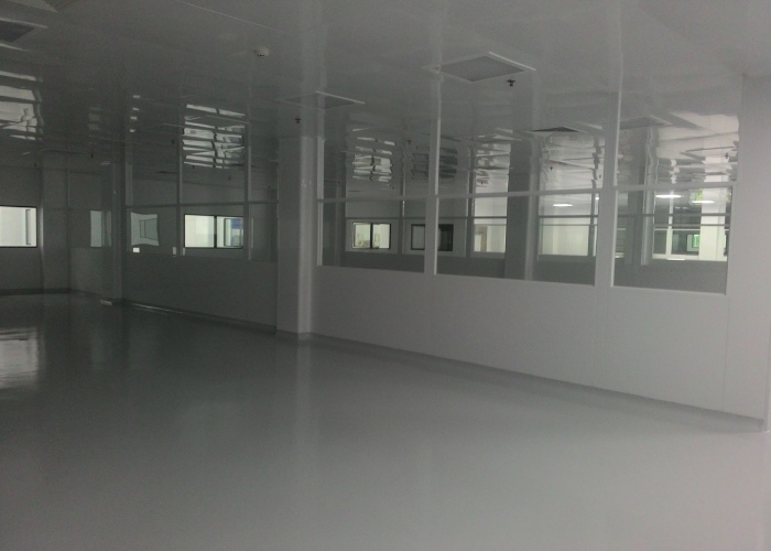 Modular cleanroom lab interior with cleanable work surfaces and HVAC ceiling diffusers