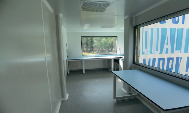Mobile pharma cleanroom interior with cleanable workbench and controlled clean zone layout