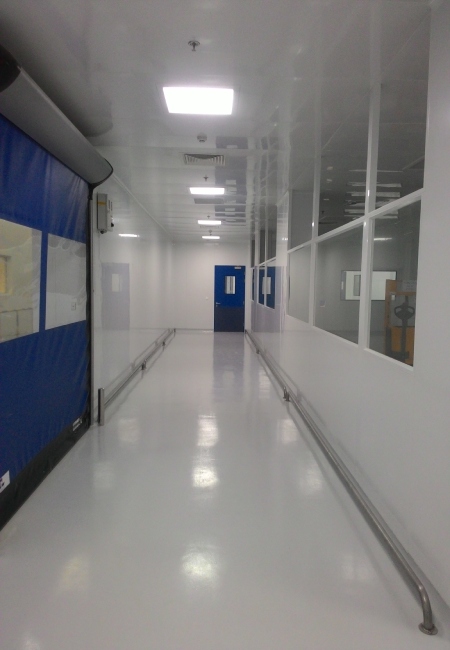 Sterile filling cleanroom corridor with integrated wall panels ceiling lights pressure indicators and cleanroom doors