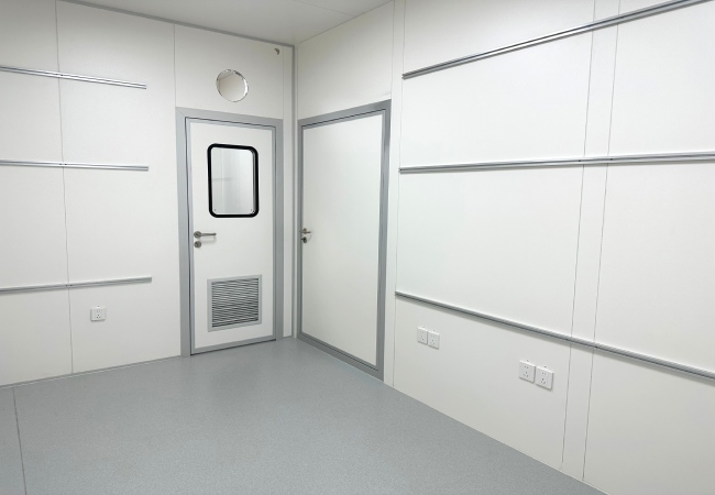 Factory built container laboratory module for temporary pharmaceutical QC space with cleanroom panels and cleanroom door